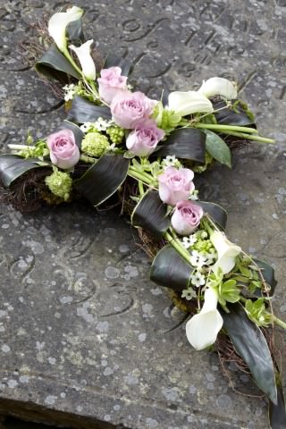 <h2>Contemporary Cross-Shaped Design | Funeral Flowers</h2>
<br>
<ul>
<li>Approximate Size 3 ft</li>
<li>Hand created white and lilac contemporary cross in fresh flowers</li>
<li>To give you the best we may occasionally need to make substitutes</li>
<li>Funeral Flowers will be delivered at least 2 hours before the funeral</li>
<li>For delivery area coverage see below</li>
</ul>
<br>
<h2>Liverpool Flower Delivery</h2>
<br>
<p>We have a wide selection of Funeral Crosses offered for Liverpool Flower Delivery. Funeral Crosses can be provided for you in Liverpool, Merseyside and we can organize Funeral flower deliveries for you nationwide. Funeral Flowers can be delivered to the Funeral directors or a house address. They can not be delivered to the crematorium or the church.</p>
<br>
<h2>Flower Delivery Coverage</h2>
<br>
<p>Our shop delivers funeral flowers to the following Liverpool postcodes L1 L2 L3 L4 L5 L6 L7 L8 L11 L12 L13 L14 L15 L16 L17 L18 L19 L24 L25 L26 L27 L36 L70 If your order is for an area outside of these we can organise delivery for you through our network of florists. We will ask them to make as close as possible to the image but because of the difference in stock and sundry items it may not be exact.</p>
<br>
<h2>Liverpool Funeral Flowers | Crosses</h2>
<br>
<p>This contemporary funeral cross has been loving handcrafted by our expert florists and features white calla lilies, lilac roses and chincherinchees together with luscious green foliage to complete this classic design.</p>
<br>
<p>Funeral crosses are symbols of belief they reaffirm faith and provide comfort at this difficult time.</p>
<br>
<p>In the larger sizes (from 4ft up) they are appropriate as the main tribute but smaller sizes are sometimes chosen by close friends as they represent extremely personal sentiments and feelings.</p>
<br>
<p>This 3ft cross contains 6 memory lane roses, 3 chincherinchees, 6 white calla lilies, 2 helleborus, clematis vine, viburnum opulus, cordyline fruticosa and muehlenbeckia.</p>
<br>
<h2>Best Florist in Liverpool</h2>
<p>Trust Award-winning Liverpool Florist, Booker Flowers and Gifts, to deliver funeral flowers fitting for the occasion delivered in Liverpool, Merseyside and beyond. Our funeral flowers are handcrafted by our team of professional fully qualified who not only lovingly hand make our designs but hand-deliver them, ensuring all our customers are delighted with their flowers. Booker Flowers and Gifts your local Liverpool Flower shop.</p>
<br>
<p><em>Janice Crane - 5 Star Review on Google - Funeral Florist Liverpool</em></p>
<br>
<p><em>I recently had to order a floral tribute for my sister in laws funeral and the Booker Flowers team created a beautifully stunning arrangement. Thank you all so much, Janice Crane.</em></p>